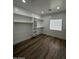 Bright walk-in closet with built-in shelving, wood floor, and natural light from a glass block window at 333 W Bethany Home Rd, Phoenix, AZ 85013