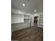Large walk-in closet with custom shelving and a view into an adjoining room with decorative accent panels at 333 W Bethany Home Rd, Phoenix, AZ 85013