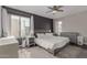 Spacious bedroom with a dark accent wall, large windows, and a ceiling fan at 3600 N Hayden Rd # 2816, Scottsdale, AZ 85251