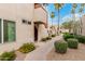 Inviting condo exterior with desert landscaping, sidewalk, and palm trees, set against a blue sky at 3600 N Hayden Rd # 2816, Scottsdale, AZ 85251