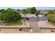 Aerial view of the property featuring lush landscaping, a long driveway and a detached garage at 4112 W Monte Cristo Ave, Phoenix, AZ 85053