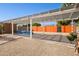 View of the backyard featuring a covered area with gravel and brick details and a colorful block wall at 4112 W Monte Cristo Ave, Phoenix, AZ 85053