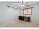 Carpeted bedroom with a ceiling fan, window, and some shelving at 4112 W Monte Cristo Ave, Phoenix, AZ 85053