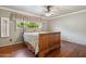 Comfortable bedroom with hardwood floors, ceiling fan, and ample natural light at 4112 W Monte Cristo Ave, Phoenix, AZ 85053