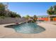 Inviting freeform pool with rock waterfall feature in a landscaped backyard setting at 4112 W Monte Cristo Ave, Phoenix, AZ 85053