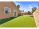 Spacious backyard with artificial grass, a patio, and a playset at 4204 S Winter Ln, Gilbert, AZ 85297