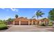 Charming single-story home with a three-car garage, desert landscaping and mature palm trees at 4204 S Winter Ln, Gilbert, AZ 85297