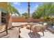 Inviting backyard featuring a fire pit with seating, palm trees, and desert landscaping at 4204 S Winter Ln, Gilbert, AZ 85297