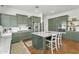 Spacious kitchen with green cabinets, stainless steel appliances, white countertops, and terracotta tile flooring at 4204 S Winter Ln, Gilbert, AZ 85297