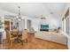 Open floorplan living room with dining area, terracotta floors, and neutral decor at 4204 S Winter Ln, Gilbert, AZ 85297