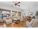 Bright living room with tile flooring, a ceiling fan, and a view of the outdoor pool at 4204 S Winter Ln, Gilbert, AZ 85297