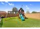Spacious backyard with artificial grass and a playset at 4204 S Winter Ln, Gilbert, AZ 85297