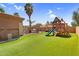 Lush backyard with a playground, barbecue area, and well-maintained artificial grass at 4204 S Winter Ln, Gilbert, AZ 85297