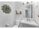 Charming powder room with decorative mirror, vanity with sink and toilet at 4204 S Winter Ln, Gilbert, AZ 85297
