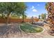 Lush backyard oasis with a putting green, desert landscaping, and mature trees at 4204 S Winter Ln, Gilbert, AZ 85297