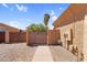 Side yard with a gravel landscape and a wooden gate at 4204 S Winter Ln, Gilbert, AZ 85297