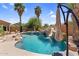 Beautiful backyard featuring a pool with a slide, mature landscaping, and patio seating at 4204 S Winter Ln, Gilbert, AZ 85297