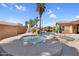 Resort-style pool and spa with rock waterfall feature and lush landscaping at 4204 S Winter Ln, Gilbert, AZ 85297