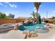 Inviting swimming pool with a waterfall, spa, and lush tropical landscaping at 4204 S Winter Ln, Gilbert, AZ 85297