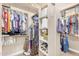 A walk-in closet with neatly organized shelves and rods filled with clothing and storage boxes at 4204 S Winter Ln, Gilbert, AZ 85297