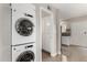 Convenient laundry area with stacked washer and dryer, storage space, and easy access to the kitchen at 4600 N 68Th St # 302, Scottsdale, AZ 85251