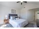 Well-lit bedroom featuring gray headboard, white bedding, side tables with lamps, and a ceiling fan at 480 S Seawynds Blvd, Gilbert, AZ 85233