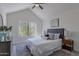Bright bedroom featuring a vaulted ceiling, a ceiling fan, and a large window with outdoor views at 480 S Seawynds Blvd, Gilbert, AZ 85233