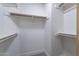 Walk-in closet with built-in shelving and wooden rods at 480 S Seawynds Blvd, Gilbert, AZ 85233