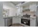 Updated kitchen features stainless steel appliances, white cabinets, and stone countertops at 480 S Seawynds Blvd, Gilbert, AZ 85233