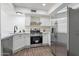 Updated kitchen features stainless steel appliances, white cabinets, and stone countertops at 480 S Seawynds Blvd, Gilbert, AZ 85233