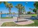 Comfortable bench by the lake, offering a peaceful spot with palm tree views at 480 S Seawynds Blvd, Gilbert, AZ 85233