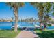 Picturesque view of waterfront homes with a dock, framed by lush palm trees at 480 S Seawynds Blvd, Gilbert, AZ 85233