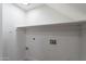 A spacious laundry room with utility hookups and shelving at 480 S Seawynds Blvd, Gilbert, AZ 85233