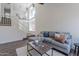 Spacious living room with large windows, comfortable seating, and staircase leading to upper level at 480 S Seawynds Blvd, Gilbert, AZ 85233