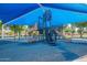 Bright and colorful playground featuring slides and swings under a shaded structure at 480 S Seawynds Blvd, Gilbert, AZ 85233