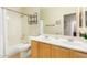 Bathroom featuring a double vanity, toilet, tub, and shower combination at 4822 E Charleston Ave, Scottsdale, AZ 85254