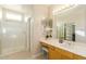 Well-lit bathroom with walk-in shower, vanity with a large mirror and closet space at 4822 E Charleston Ave, Scottsdale, AZ 85254