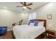Bright bedroom with hardwood floors, ceiling fan, and large window offering plenty of natural light at 4822 E Charleston Ave, Scottsdale, AZ 85254