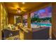 Covered patio with ample seating, fan and view of the pool and lush landscaping at 4822 E Charleston Ave, Scottsdale, AZ 85254