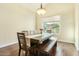 Bright dining room featuring a wooden table with bench seating and light hardwood floors at 4822 E Charleston Ave, Scottsdale, AZ 85254