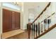 Bright foyer featuring hardwood floors, staircase with white railings and a double door entry at 4822 E Charleston Ave, Scottsdale, AZ 85254
