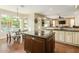 Open kitchen and dining area with granite countertops, hardwood floors, and stainless steel appliances at 4822 E Charleston Ave, Scottsdale, AZ 85254
