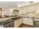 Gourmet kitchen featuring white cabinets, granite countertops, stainless steel appliances, and hardwood floors at 4822 E Charleston Ave, Scottsdale, AZ 85254
