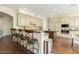 Bright kitchen with large island, breakfast bar seating, white cabinets and stainless steel appliances at 4822 E Charleston Ave, Scottsdale, AZ 85254