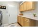 Well-organized laundry room with ample cabinet and counter space, plus a convenient utility sink at 4822 E Charleston Ave, Scottsdale, AZ 85254