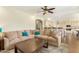 Large living room open to kitchen includes a ceiling fan, hardwood floors, and comfortable seating at 4822 E Charleston Ave, Scottsdale, AZ 85254