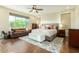 Spacious main bedroom with hardwood floors, a ceiling fan, and a large window at 4822 E Charleston Ave, Scottsdale, AZ 85254