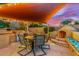 Outdoor dining area with a built-in grill, fireplace, and ample seating, ideal for entertaining at 4822 E Charleston Ave, Scottsdale, AZ 85254