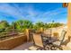 Relaxing covered outdoor patio with seating, offering stunning views of lush trees and clear skies at 4822 E Charleston Ave, Scottsdale, AZ 85254