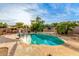 Backyard oasis with a sparkling pool, lounge area, shade and outdoor kitchen at 4822 E Charleston Ave, Scottsdale, AZ 85254